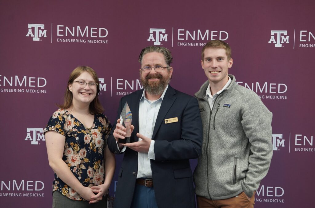 Dr. Rhome poses with award after receiving R. Kelly Hester Distinguished Teaching Award